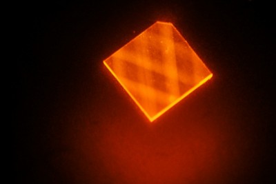 In this image, laser light enters a synthetic diamond from a facet at its corner and bounces around inside the diamond until its energy is exhausted. This excites "nitrogen vacancies" that can be used to measure magnetic fields. image: H. Clevenson/MIT Lincoln Laboratory